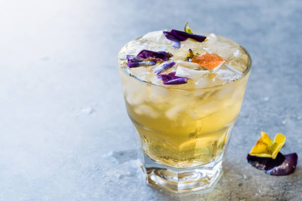 istock Herbal Iced Tea Cocktail with Edible Flowers and Crushed Ice. 959193254