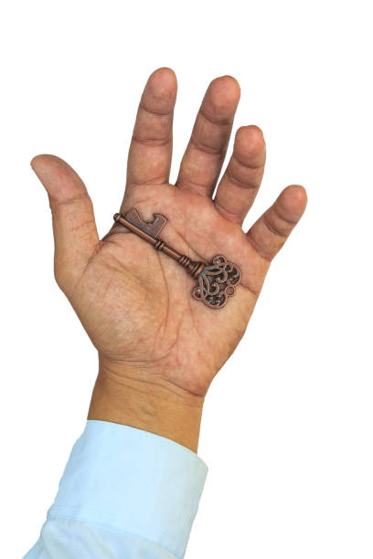 istock Businessman holding key on white background.Close up 959193352