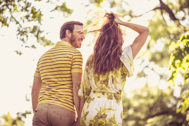 istock Walking trough nature. Middle age couple. From back. 959194052