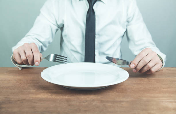 istock Man showing fork with knife. Time to eat 959198352