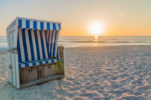 Beach chair in the sunset on Sylt Beach chair at sunset on Sylt german north sea region stock pictures, royalty-free photos & images