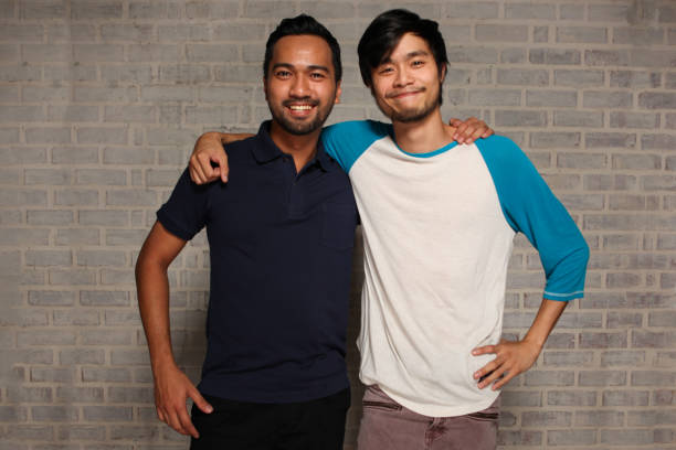 istock Two Male Friends With Arms Around Each Other 959206736