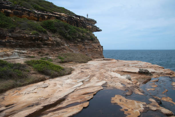 istock Stream over sandstone with view of ocean 959209566