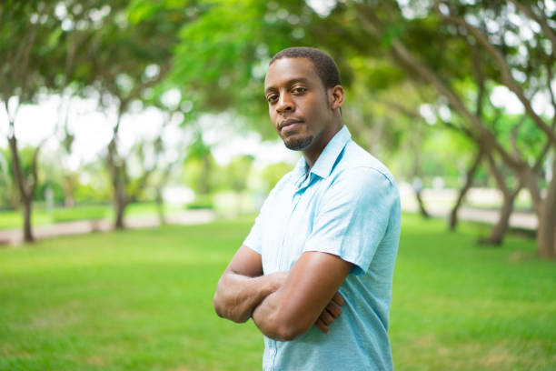 istock Ambitious confident young black man with beard in summer park 959210384