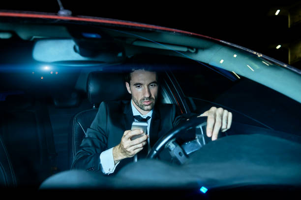 istock businessman using his smartphone while sitting in the car 959211160
