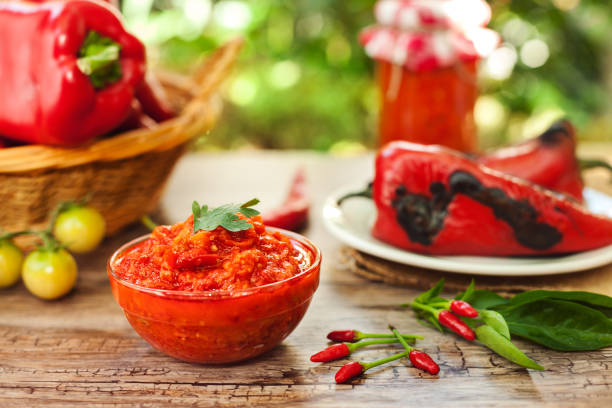 istock Traditional ajvar in bowl with chili peppers 959211288