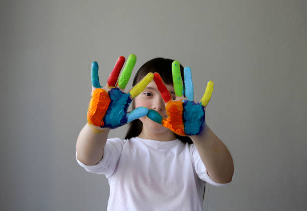 istock Cute little girl with painted hands. 959212648