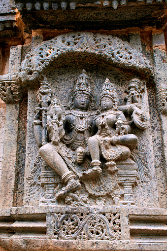 Sulpture Lakshmi sitting in the lap of Vishnu. Kedareshwara Temple, Halebid, Karnataka, india. North Wall.