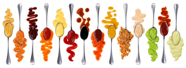 Set of different sauces with spoons isolated on white background Set of different sauces with spoons isolated on white background with clipping path mustard fruits stock pictures, royalty-free photos & images