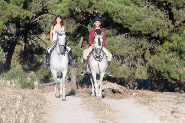 istock man and woman on horseback 959215732