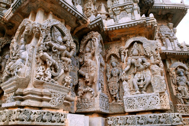 istock Ornate wall panel reliefs depicting (From left) dancing Shiva, Krishna as Kaliya-mardana and a deity and dancing Parvati, Kedareshwara temple, Halebidu, Karnataka, india. 959215808
