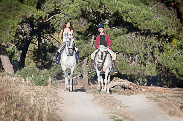 istock man and woman on horseback 959216008
