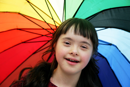 Portrait of little girl smiling on background of the umbrella