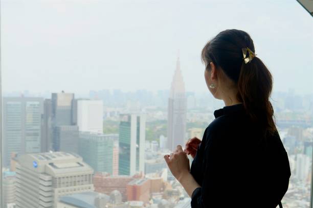 istock Young woman enjoying cityscape 959223080