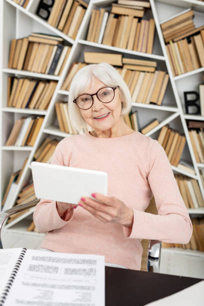 istock Attractive senior woman learning online 959224466