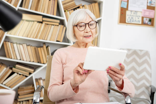 istock Pensive senior woman educating online 959224646