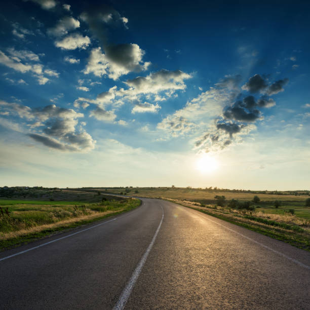 istock asphalt road closeup and dramatic clouds in dark sky in sunset 959227826