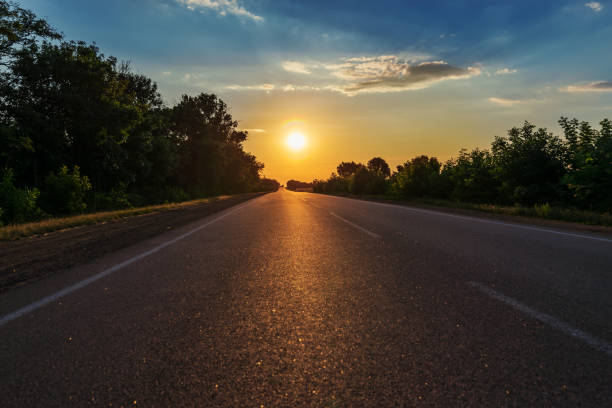 istock asphalt road to horizon in sunset 959228484