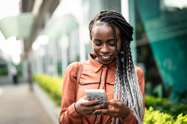istock Afro Woman Using Mobile at Street 959233324