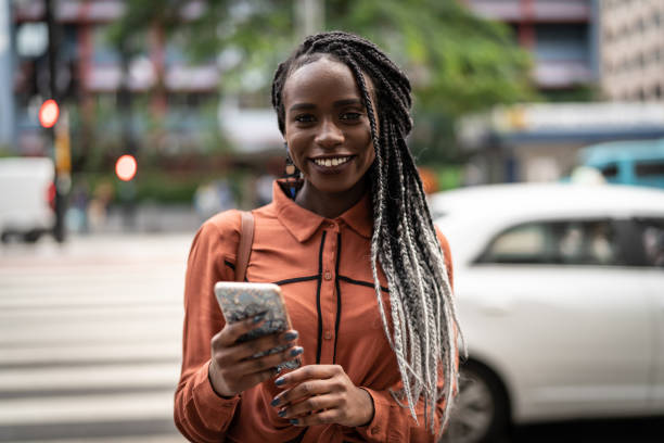 istock Afro Woman Using Mobile at Street 959233914