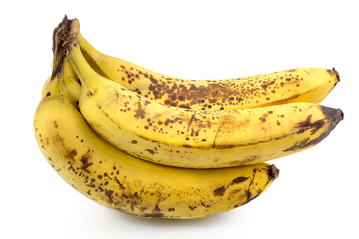 Ripe yellow bananas fruits, bunch of ripe bananas with dark spots on a white background with clipping path.
