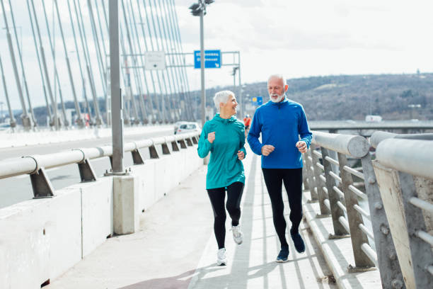 istock Old couple exercising outdoors by the street 959244010
