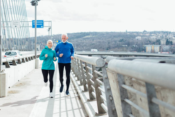 istock Senior couple exercising on city bridge 959244026