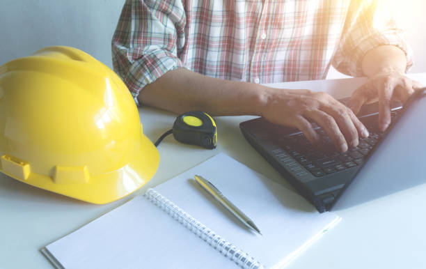 istock Architect engineer working concept with laptop and construction tools or safety equipment on table. 959247880