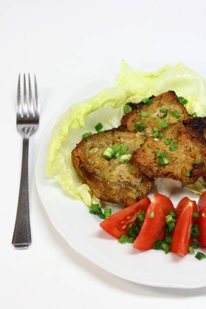 istock grilled pork chops with tomatoes, lettuce and chives 959248496