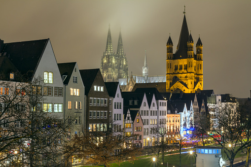 Cityscape - evening view on the Rhine promenade on background the Great Saint Martin Church and Cologne Cathedral, North Rhine-Westphalia, Germany