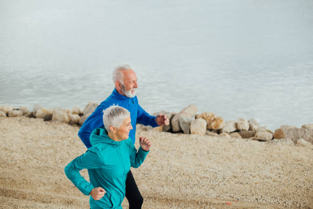 Senior couple jogging by the river