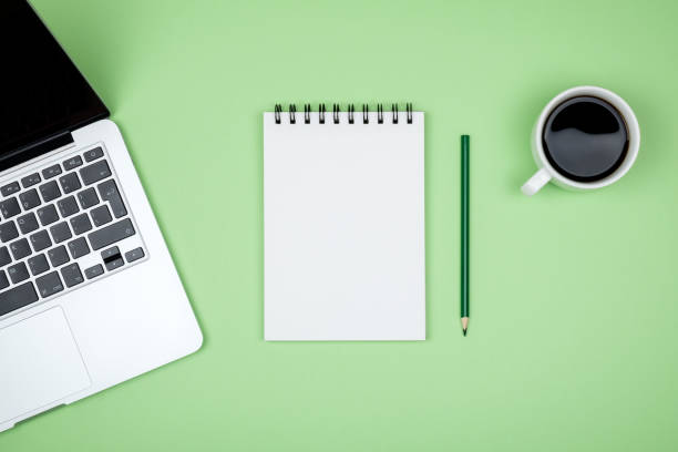istock Minimal working desk with laptop and blank notepad page. Top view, flat lay and copy space 959251466