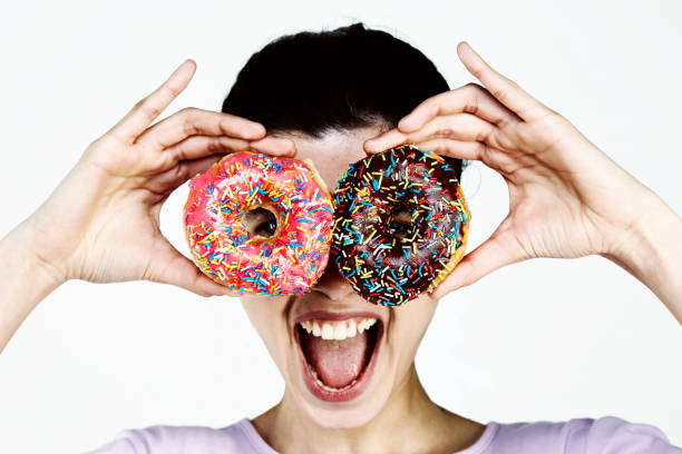 istock Young Woman holding donut 959251588