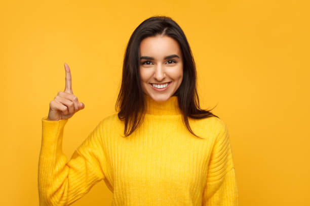 istock Smiling brunette showing finger up 959251884