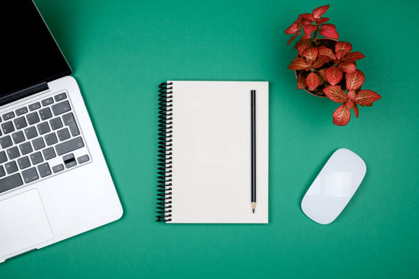 istock Minimal working desk with laptop and blank notepad page. Top view, flat lay and copy space 959253566