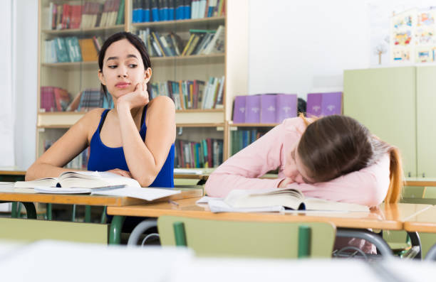 istock Girl is tired and sleeping at the desk 959257268