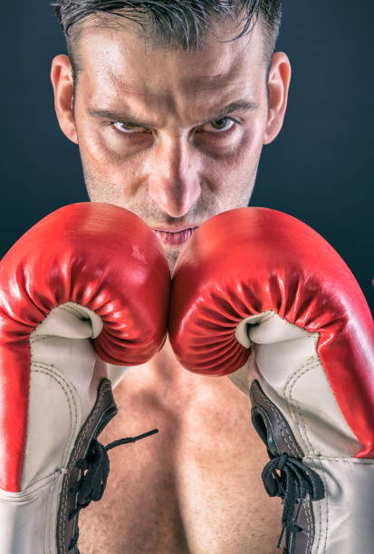 istock Athlete boxing with gloves at competition in boxing ring 959264504