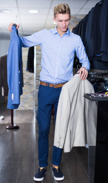 istock positive male in shirt holding jackets 959270014