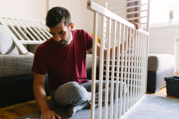istock Preparing the crib for new family member 959274146