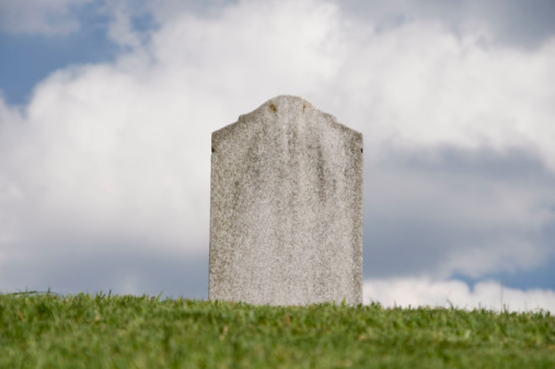 Calgary, Alberta, Canada â October 9, 2022: Tombstones in a Chinese graveyard on the hill in Calgary with a blue sky in the background