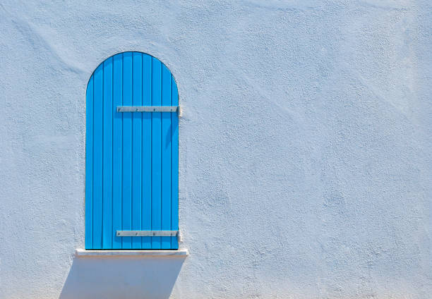 istock Blue wooden window on white wall 959279306