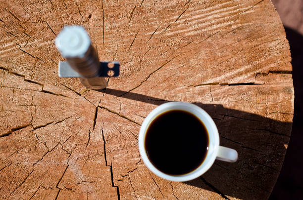 A top down view of the morning coffee and a knife in the log to start off the day.