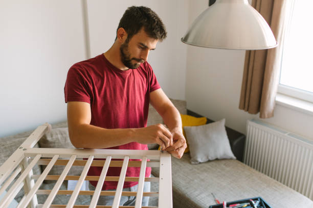 istock Preparing the crib for new family member 959287062