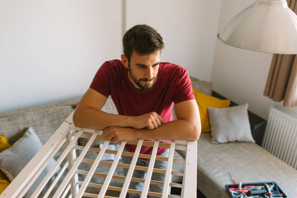 istock Preparing the crib for new family member 959287208