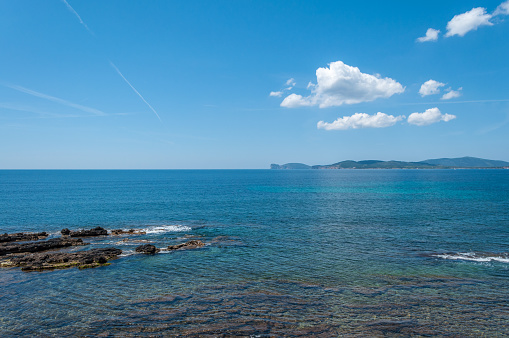 view of the coast of capo caccia from the city of alghero in a sunny day of spring