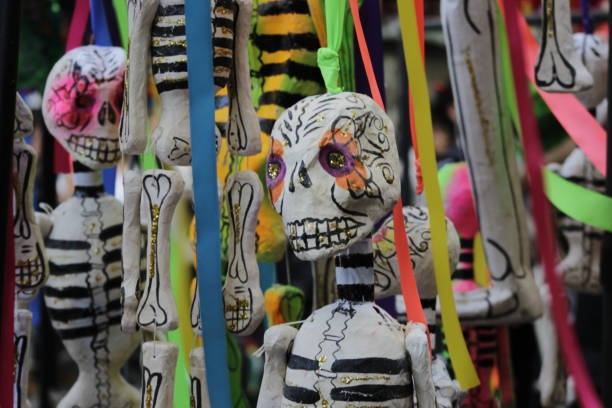 Senior woman selling day of the dead decoration at market