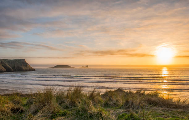 Landscape image of Wormshead Rhossili in Swansea Landscape image of Wormshead Rhossili in Swansea, South Wales at sunset rhossili bay stock pictures, royalty-free photos & images