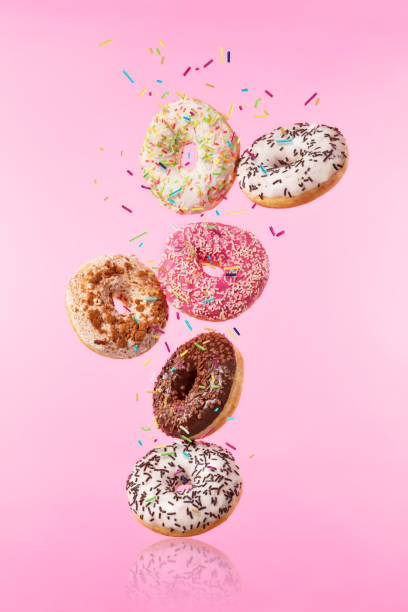 istock Flying sweet donuts isolated on pink background. 959289664