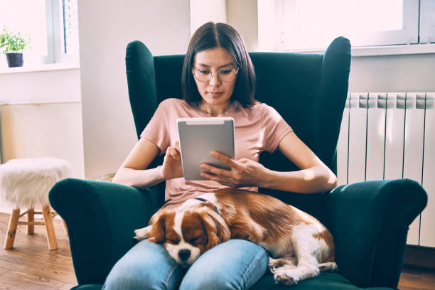 young woman relaxing at home using her tablet