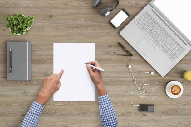 istock Business man writing on a plank paper at an office desk 959295460